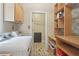Bright laundry room with washer, dryer, and custom shelving for organized storage and convenience at 959 Cedar Falls Sw Ct, Lilburn, GA 30047