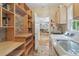 Convenient laundry area with modern appliances, sink, and custom shelves for efficient storage at 959 Cedar Falls Sw Ct, Lilburn, GA 30047