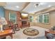 Inviting living room with fireplace, wood beams, and windows for natural light at 959 Cedar Falls Sw Ct, Lilburn, GA 30047