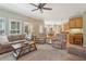 Spacious living room with carpet, comfortable seating, and an open layout to dining area at 959 Cedar Falls Sw Ct, Lilburn, GA 30047