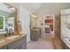 Spacious bathroom with a soaking tub, glass-enclosed shower, and double sink vanity at 959 Cedar Falls Sw Ct, Lilburn, GA 30047