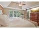 Well lit main bedroom features a sliding wood door, a large window, and an inviting king-sized bed at 959 Cedar Falls Sw Ct, Lilburn, GA 30047