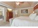 Spacious main bedroom features a tray ceiling, wood accent wall, and en-suite bathroom at 959 Cedar Falls Sw Ct, Lilburn, GA 30047