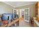 Comfortable home office with French doors leading to the dining area, built-in shelves and custom desk at 959 Cedar Falls Sw Ct, Lilburn, GA 30047