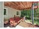 Covered patio with a relaxing swing, perfect for enjoying the outdoors in comfort at 959 Cedar Falls Sw Ct, Lilburn, GA 30047
