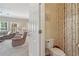 Half bath featuring stylish wallpaper, toilet, and glimpse of living area at 959 Cedar Falls Sw Ct, Lilburn, GA 30047