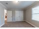 Bedroom with neutral paint and carpet, and a double-door closet at 2366 Forrest Park Se Rd, Atlanta, GA 30315