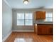 Bright dining area with natural light, hardwood floors, neutral paint, and wooden cabinets at 2366 Forrest Park Se Rd, Atlanta, GA 30315