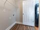 Laundry room with hookups and modern flooring near exterior door at 2366 Forrest Park Se Rd, Atlanta, GA 30315