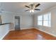 Living space with hardwood floors, natural light, view into the kitchen, and neutral walls and ceiling at 2366 Forrest Park Se Rd, Atlanta, GA 30315