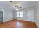 Hardwood floors fill the living space that boasts a ceiling fan, light-colored walls, and access to other areas of the home at 2366 Forrest Park Se Rd, Atlanta, GA 30315