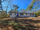 Newly renovated ranch home with a blue front door and landscaped yard at 3284 Boring Rd, Decatur, GA 30034