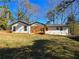 Back view of the house showing a wooden deck and backyard at 3284 Boring Rd, Decatur, GA 30034