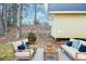 A cozy backyard setup with cushioned outdoor furniture and a small storage building at 5084 Brittany Dr, Stone Mountain, GA 30083