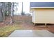 A backyard featuring a small storage building and a concrete patio at 5084 Brittany Dr, Stone Mountain, GA 30083