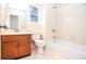 Standard bathroom featuring a vanity, toilet, and bathtub with tiled walls at 5084 Brittany Dr, Stone Mountain, GA 30083