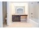 Bright bathroom featuring a single sink vanity, large mirror, shower-tub combo and a toilet in its own space at 5084 Brittany Dr, Stone Mountain, GA 30083