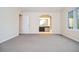 View of a bedroom with neutral walls and plush carpet, leading to a bathroom with dark wood cabinets at 5084 Brittany Dr, Stone Mountain, GA 30083