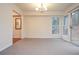 Well lit dining room with carpeted floors and sliding glass door at 5084 Brittany Dr, Stone Mountain, GA 30083