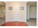 Hallway with hardwood floors and neutral-colored walls leading to multiple rooms at 5084 Brittany Dr, Stone Mountain, GA 30083