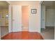 Hallway with hardwood floors and neutral-colored walls leading to multiple rooms at 5084 Brittany Dr, Stone Mountain, GA 30083