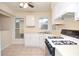 Bright kitchen with a gas stove, tile floor, and a window over the sink at 5084 Brittany Dr, Stone Mountain, GA 30083