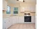 Functional kitchen with white cabinets and essential appliances at 5084 Brittany Dr, Stone Mountain, GA 30083