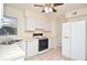 Bright kitchen with white appliances and tile floors at 5084 Brittany Dr, Stone Mountain, GA 30083