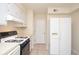 Functional kitchen featuring a gas stove, white cabinets, and a side-by-side refrigerator at 5084 Brittany Dr, Stone Mountain, GA 30083