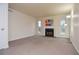 Bright living room featuring a fireplace, large windows and neutral carpet at 5084 Brittany Dr, Stone Mountain, GA 30083