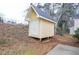 A small backyard storage building with double doors at 5084 Brittany Dr, Stone Mountain, GA 30083