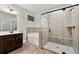 Bathroom with soaking tub, glass shower, and dark wood vanity at 554 Lance View Ln, Lawrenceville, GA 30045