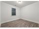 Bright bedroom with wood-look flooring and large window at 554 Lance View Ln, Lawrenceville, GA 30045