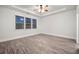 Bright bedroom with ceiling fan and wood-look flooring at 554 Lance View Ln, Lawrenceville, GA 30045