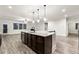 Large kitchen island with granite countertop and dark wood cabinets at 554 Lance View Ln, Lawrenceville, GA 30045