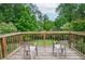 An inviting deck showcases peaceful outdoor seating with a view of lush greenery at 830 Montego Sw Way, Lilburn, GA 30047