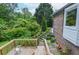 A charming outdoor deck offers a relaxing space beside beautiful landscaped gardens at 830 Montego Sw Way, Lilburn, GA 30047