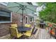 Inviting back deck with outdoor dining set, umbrella, grill, and lovely wooded backyard for peaceful outdoor living at 830 Montego Sw Way, Lilburn, GA 30047