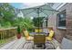 Back deck with outdoor dining set and umbrella, perfect for enjoying the wooded scenery at 830 Montego Sw Way, Lilburn, GA 30047