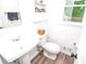 Modern powder room featuring a pedestal sink and updated fixtures at 830 Montego Sw Way, Lilburn, GA 30047