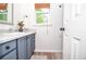Bathroom with white counters, wood floors, and gray cabinets at 830 Montego Sw Way, Lilburn, GA 30047