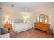Well-lit primary bedroom featuring hardwood floors and crown molding at 830 Montego Sw Way, Lilburn, GA 30047
