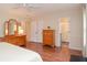 Primary bedroom featuring wood floors and an ensuite bathroom at 830 Montego Sw Way, Lilburn, GA 30047