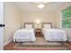 Bedroom with two twin beds, ceiling fan and a window at 830 Montego Sw Way, Lilburn, GA 30047