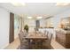 Bright dining room with long wood table and chairs, adjacent to the kitchen, perfect for gatherings at 830 Montego Sw Way, Lilburn, GA 30047