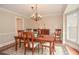 Elegant dining room with hardwood floors, chandelier, and bay window at 830 Montego Sw Way, Lilburn, GA 30047
