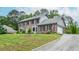 Beautiful two-story brick home with an attached garage and a well-manicured front lawn with mature trees at 830 Montego Sw Way, Lilburn, GA 30047