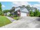 Exterior view of a two story home, showcasing a brick facade and a wide driveway at 830 Montego Sw Way, Lilburn, GA 30047