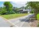 Wide exterior shot of a large home with a manicured lawn and a long driveway at 830 Montego Sw Way, Lilburn, GA 30047