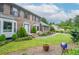 Beautiful landscaped front yard with a brick home, manicured lawn, and an inviting walkway to the front door at 830 Montego Sw Way, Lilburn, GA 30047